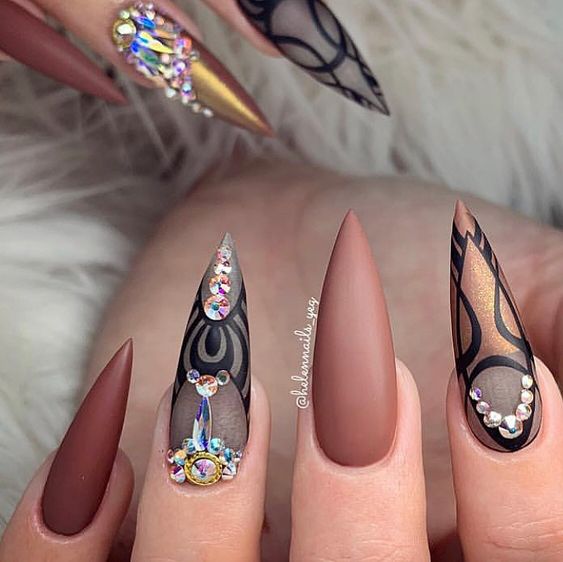 Long stiletto nails with brown matte effect and different patterns