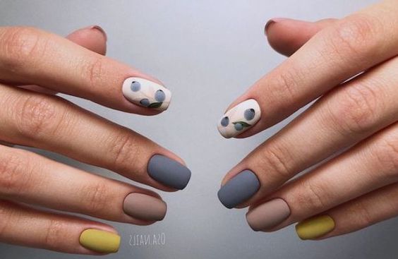 Yellow, nude, gray matte nails with white patterned point finger  