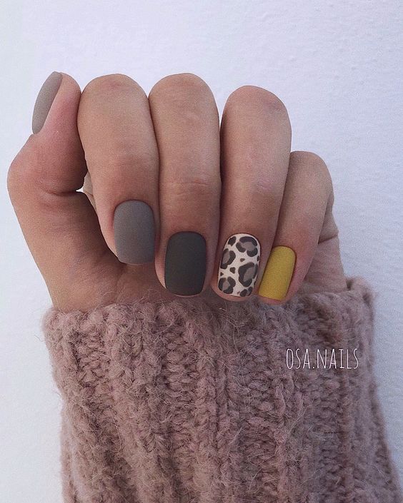 Gray and white nail design with leopard pattern 