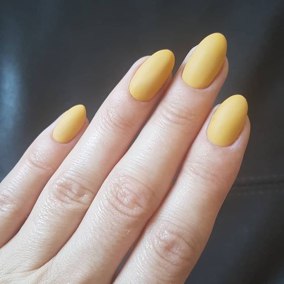 Mustard yellow almond shaped nail design 