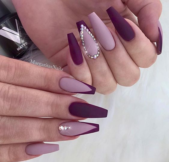 Purple and lavender coffin-shaped nails with some rhinestones 