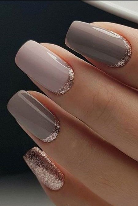 Pastel gray polish with golden shimmer at the bottom of each nail