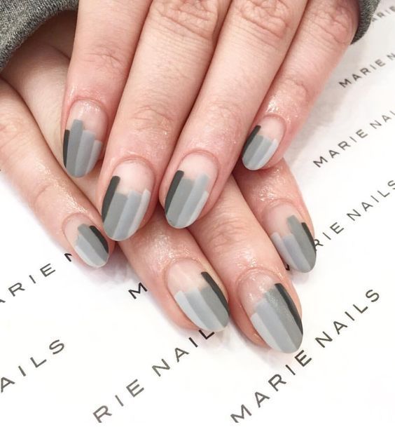 Almond shaped nails with 4 shades of gray polish