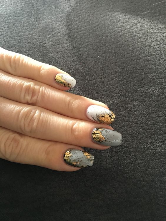 White and gray nails with black and gold motives 