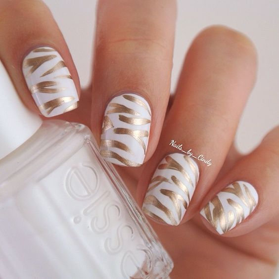 metallic gold brush strokes on white nail polish