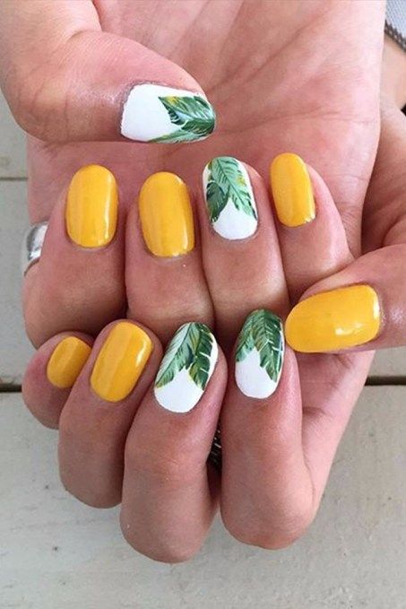yellow nails with palm leaves nail art