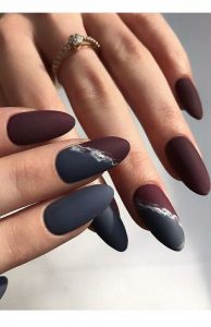 Grey and red nails with an accent nail that is half grey and half red
