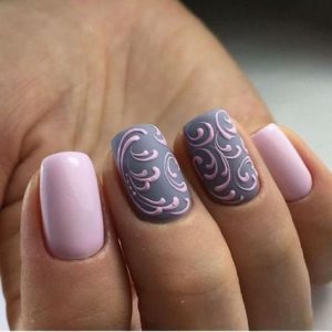 Pink swirly nail art on grey base