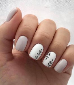 simple leaves nail art on white accent nails