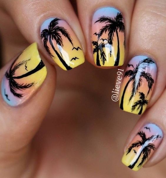 Ombre from pastel blue to yellow with palm tree nail art