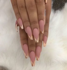 Golden tips on long coffin shaped nails