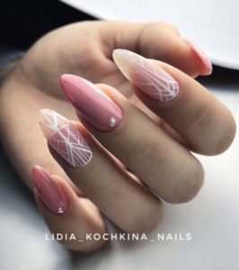 Pink nails with white geometric shapes
