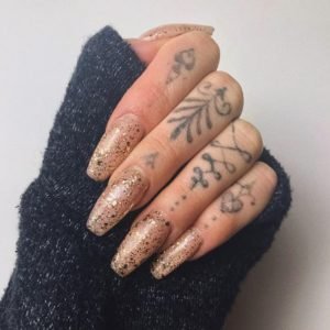 gold glitter polish over clear nails