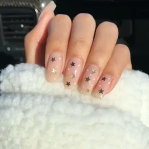 gold stars stuck over clear nails