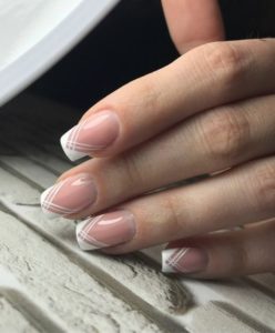 Thin lines crossing over at bottom of french manicure