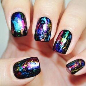 Different metallic colour nail foil on black nails