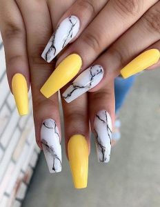 alternate yellow and marble effect nails
